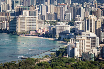 Downtown Waikiki City / View of downtown Waikiki skyline from Diamond Head Monument summit viewpoint. Many buildings and resorts line the Waikiki beach front coastline.