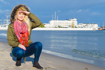 Fototapeta na wymiar Woman relaxing on beach, cold day
