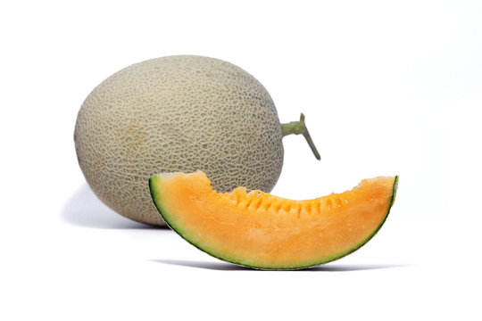 Melon fruit and sliced orange melon to show the juicy flesh on white background.