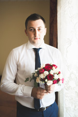 Beautiful man, groom posing and preparing for wedding
