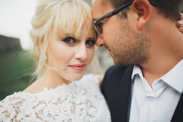 Kissing wedding couple in spring nature close-up portrait