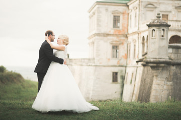 Fototapeta premium Sensual married couple, valentines hugging in front of old slavic castle