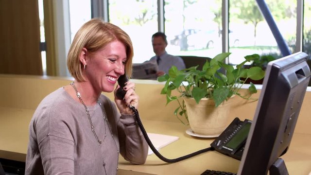 Receptionist takes a phone call