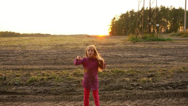 Happy white girl jumping and dancing Rock N Roll in field rural scene autumn sunset. SlowMo.
