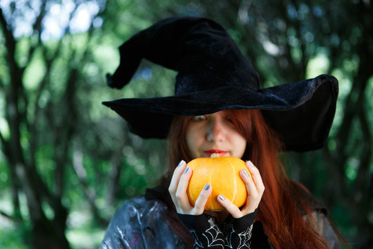 Close-up image of witch with pumpkin