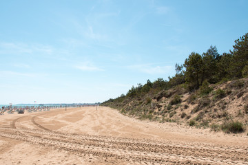 Lignano Sabbiadoro. Lighthouse, beach and umbrellas.