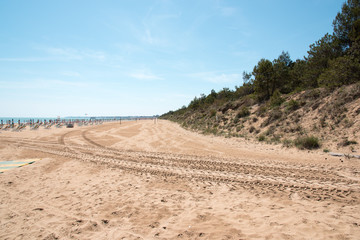 Lignano Sabbiadoro. Lighthouse, beach and umbrellas.