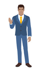 Businessman greeting someone with his hand raised up