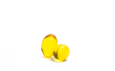 Two capsules of cod liver oil isolated on white background. Source of Omega-3 and vitamin A & D helps growth development and absorption of calcium and phosphorous in the body, just add your own text