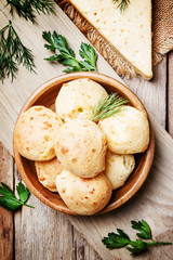 Unsweet buns with cheese, vintage wooden background, top view