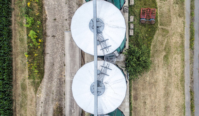 Silos in a field for storing grain, aerial view, crop of the center silo