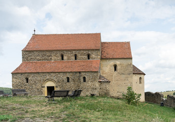 Cisnadioara, Transylvania, Romania. Fortified medieval church on top of rock hill in Cisnadioara near Sibiu, Transylvania, Romania. Cloudy summer day.