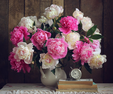 Fototapeta Bouquet of peonies in a white pitcher.