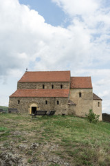 Cisnadioara, Transylvania, Romania. Fortified medieval church on top of rock hill in Cisnadioara near Sibiu, Transylvania, Romania. Cloudy summer day.