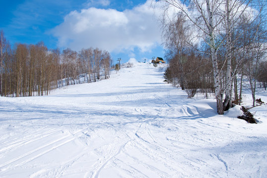 empty alpine ski slope in sunny winter day