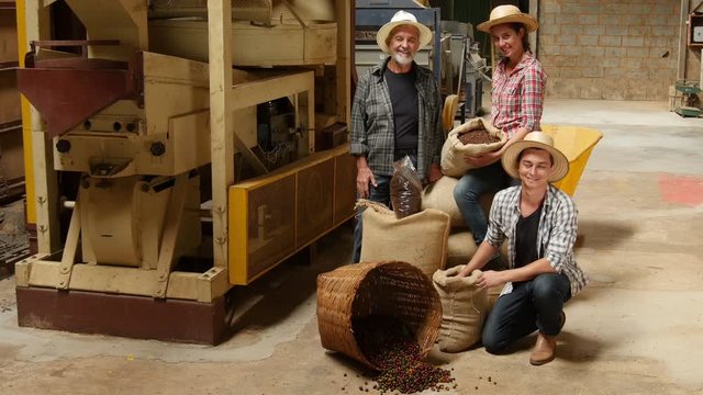 Portrait of workers with coffee bean sacks