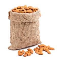 Almonds in bag from sacking isolated on white background