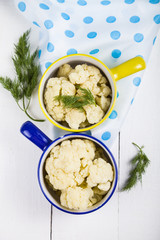 Boiled cauliflower in multi-colored bowls