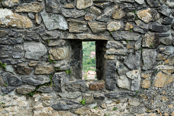 Window on the facade of stone wall