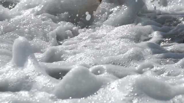 Woman legs on the peeble beach