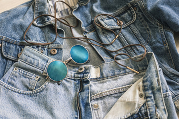 Trendy blue circle sunglasses on the jeans and jacket