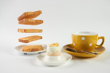 Flying toasts for breakfast and cup of fresh milk with chicken egg