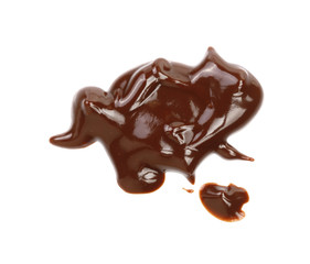 Hot melted chocolate pouring isolated on white background, top view