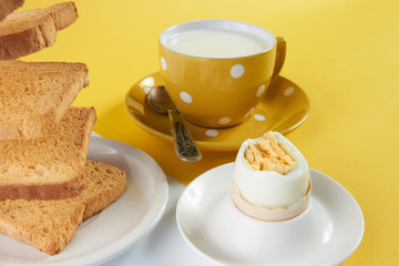 Flying toasts for breakfast and cup of fresh milk with chicken egg