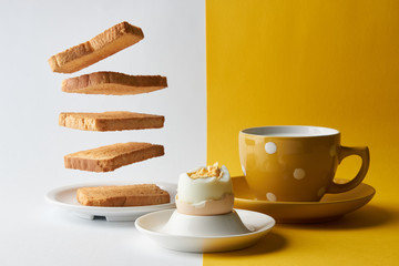 Flying toasts for breakfast and cup of fresh milk with chicken egg