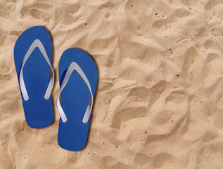 Fototapeta na wymiar Two blue man lifestyle relax flip flops on orange sandy beach