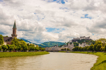 Famous classic view of historic old  city of Salzburg  with Festung Hohensalzburg. View of Salzburg over Salzach river on a sunny day. Salzburg, Austria.