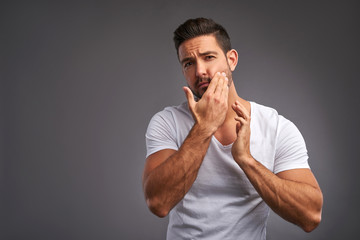 Young man checking his skin  