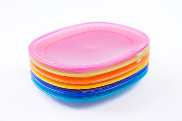 Colorful plastic plates closeup isolated on white background
