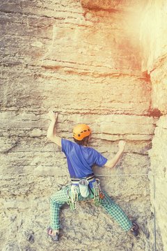 rock climber climbs on a rocky wall
