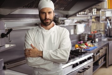 Portrait of confident chef standing with arms crossed in