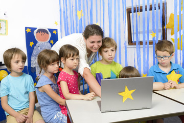 Educator Surrounded by  Kids at Kindergarten