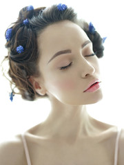 Beautiful young woman with blue muscari in her hair