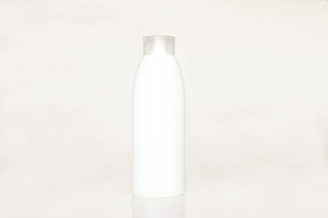 White plastic bottle with  screw cap on light white background. Clear object for design. Medicine, syrup, cosmetic lotion, shampoo or house cleaning products package