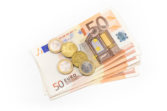 Stack of Euro banknotes and coins isolated. 50 Euro banknotes. European currency money banknotes isolated on white backdrop. Top view closeup. Salary, savings, european union economic crisis concept.