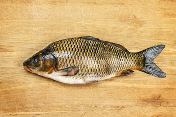 Fresh carp on cutting board