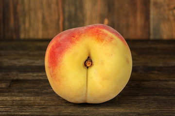 Ripe peach on wood