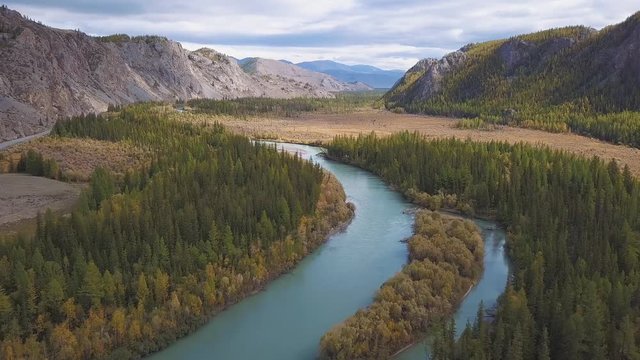 Aerial View. Flying over the beautiful mountain River. Aerial camera shot. Landscape panorama. Altai, Siberia