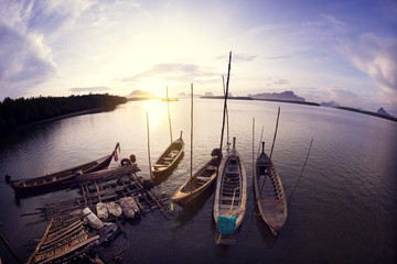 Wooden fishing boats with sunset scenery in the sea