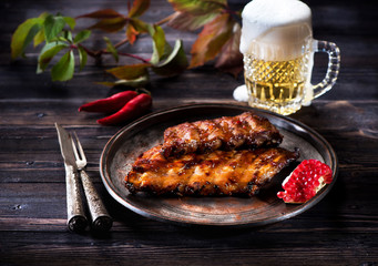 Pork ribs barbecue grill and a mug of beer