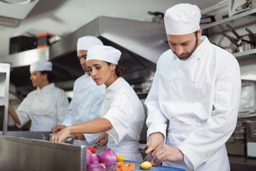 Chefs chopping vegetables