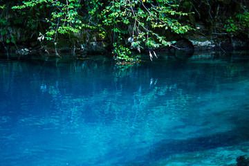 Amazing view of blue mountain lake like paradise, rock wall and colorful water .Scenery of Abkhazia paradise nature with awesome closeup perspective and fast stream.