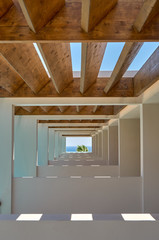 Contemporary corridor of tropical resort terrace under wooden beams