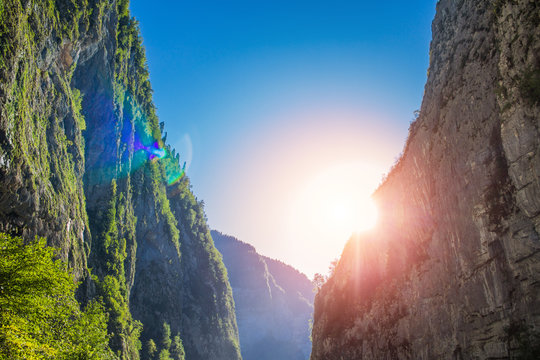 The sun shines through the gorge in the mountains