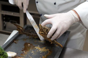Fresh prepared fish sterlet in a metal oven of restaurant kitchen. Selective focus. Shallow depth of field
