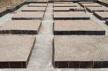 Concrete foundation blocks for a new building on a construction site